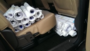 Rolled up blueprints on car seat